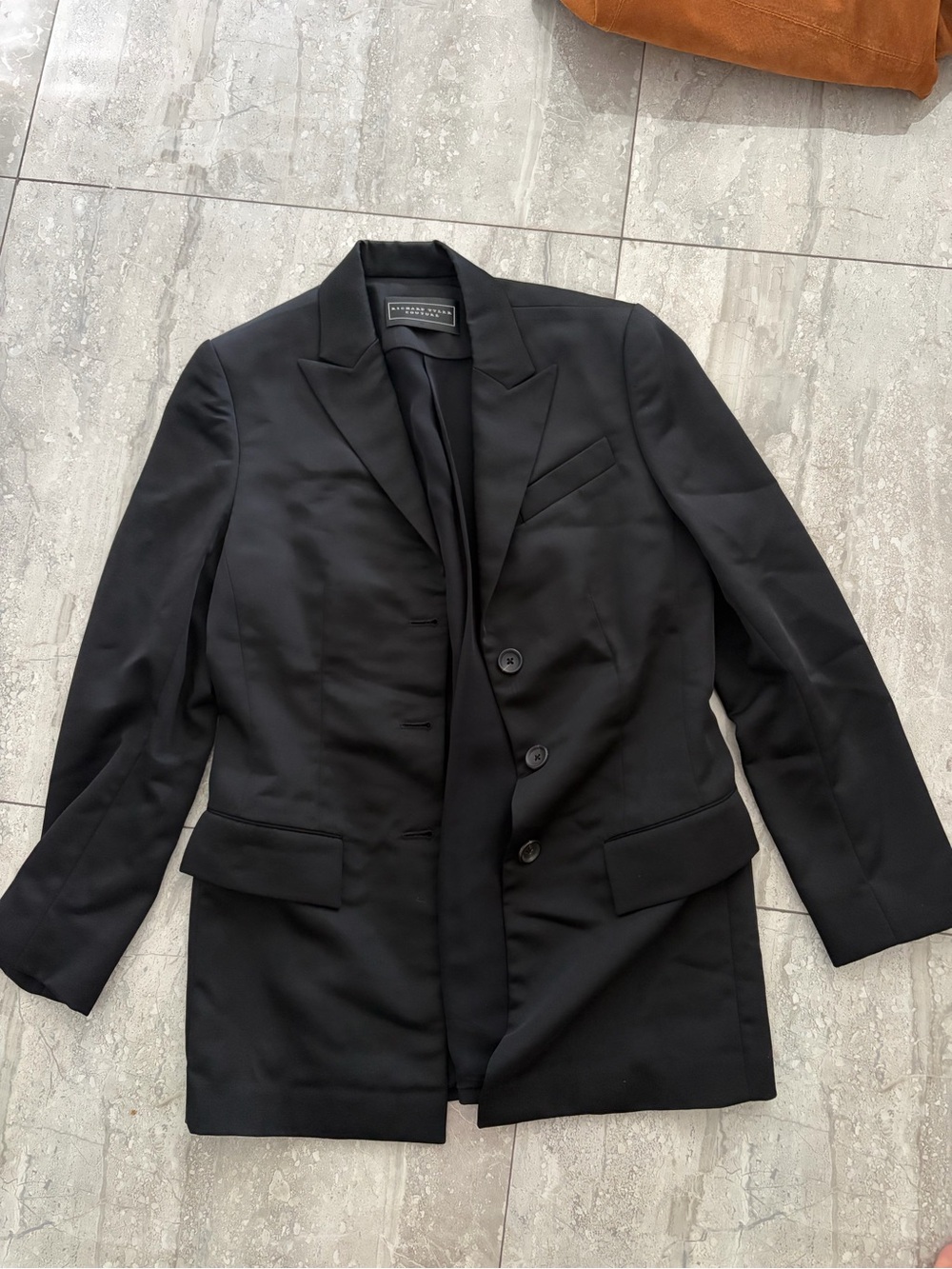 Men's black tailored coat collar with label